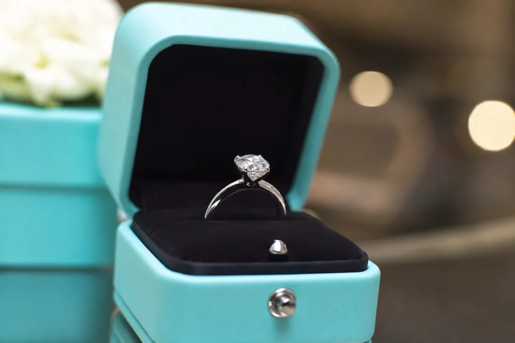 Anel solitário de diamante dentro da icônica caixa azul da marca Tiffany & Co.